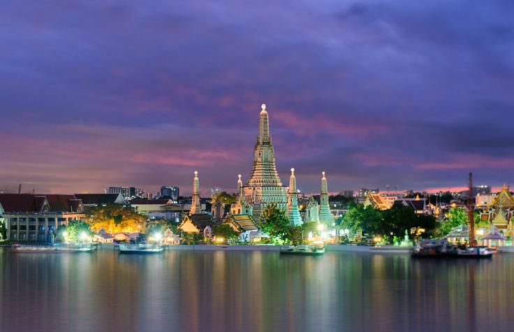 Shot of Wat Arun across the river from a rooftop bar